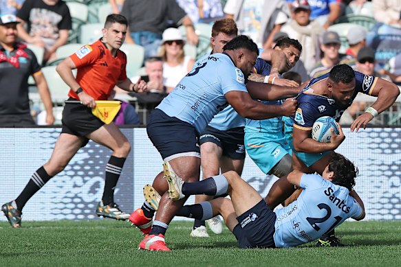 Sama Malolo of Moana Pasifika is tackled by Taniela Tupou. 