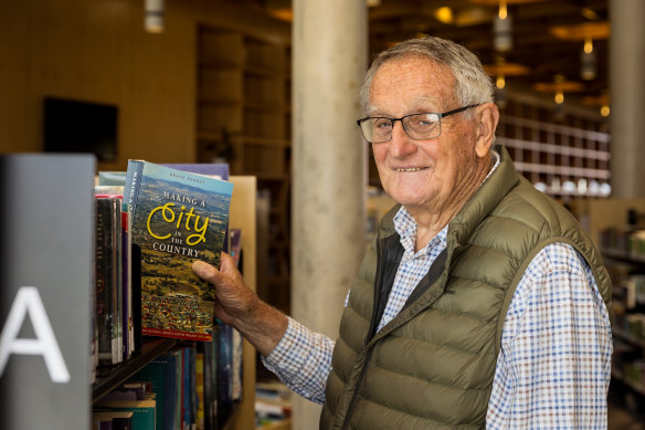 Historian Bruce Pennay with a library copy of his book, “Making a City in the Country”.