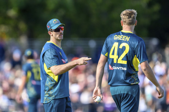 Mitchell Marsh speaks with Cameron Green during the first T20 International Series Cricket match in Edinburgh, Scotland.