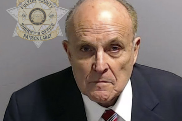 This booking photo provided by the Fulton County Sheriff’s Office shows Rudy Giuliani after he surrendered to police.