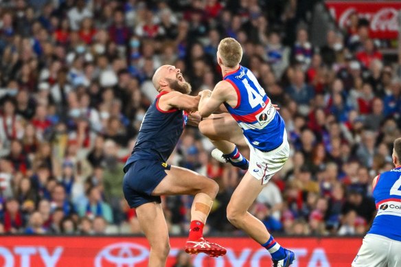 Max Gawn and Tim English leap for the ball.