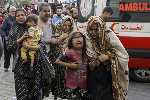 Injured Palestinians arrive at al-Shifa Hospital following Israeli airstrikes on Gaza City on Monday.