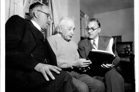 Professor Albert Einstein receives a birthday book of messages presented by the Albert Einstein College  of Medicine on his 75th birthday on March 14, 1954.