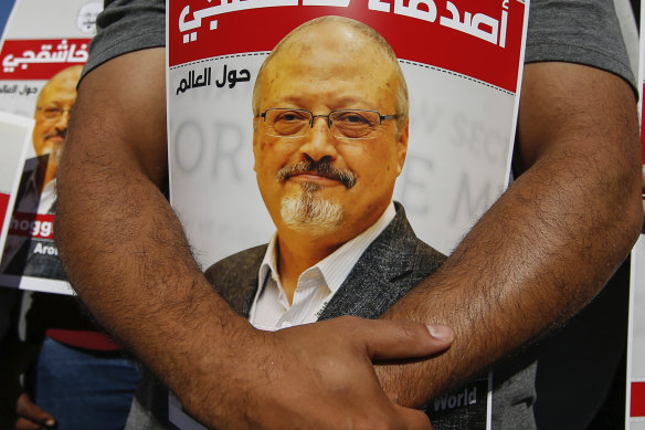 People hold posters of slain Saudi journalist Jamal Khashoggi, near the Saudi Arabia consulate in Istanbu in 2020.