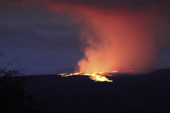 Lava pours out of the summit crater of Mauna Loa on Tuesday (AEDT).