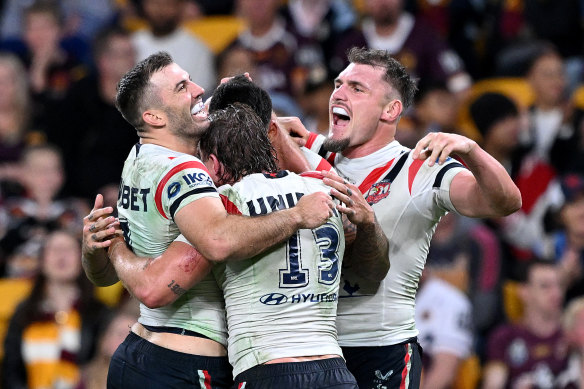 Terrell May is swarmed by teammates as the Roosters take control.
