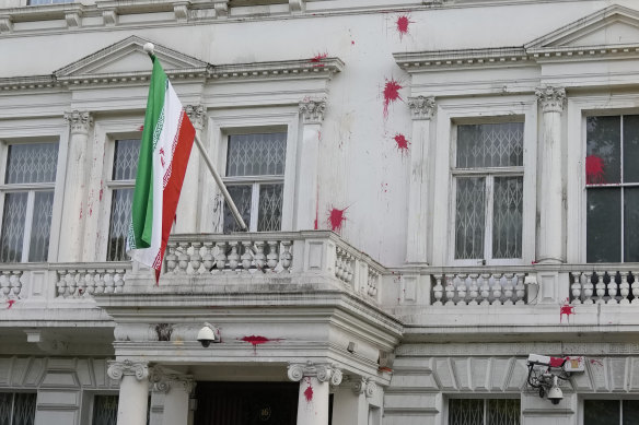 Police stand guard outside the Iranian Embassy in London after a small group of protesters threw paint at the building.