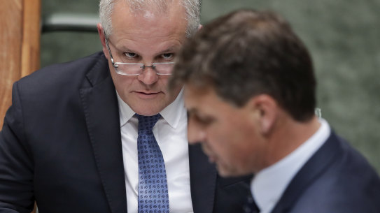 Prime Minister Scott Morrison listens as Minister for Energy Angus Taylor speaks during question time on Thursday.