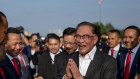 Anwar Ibrahim is greeted by the staff on assuming office last month.