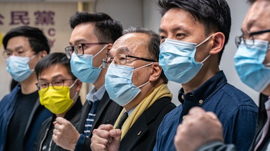 Pro-democracy activists gesture during a press conference on January 6 in Hong Kong after 50 opposition figures were arrested under the national security law.