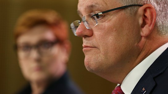 Prime Minister Scott Morrison speaks as Australian Foreign Minister Marice Payne looks on during a press conference on the cornavirus.
