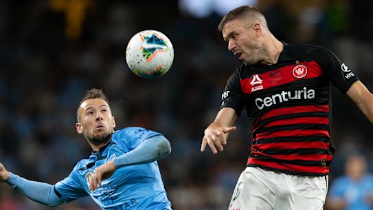 Western Sydney Wanderers defender Matthew Jurman (6) and Sydney FC forward Adam Le Fondre (9) battle for the ball during the round 3 A-League soccer match between Western Sydney Wanderers FC and Sydney FC.