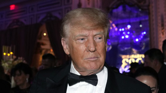 Former President Donald Trump arrives for a New Year’s Eve party at Mar-a-Lago, in Palm Beach, Florida on Saturday night.