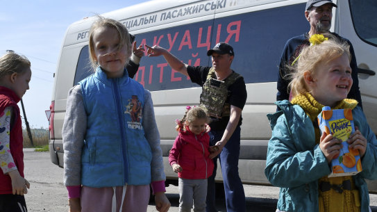 Children wait for boarding a transport during an evacuation of civilians on a road near Slovyansk, eastern Ukraine in May.