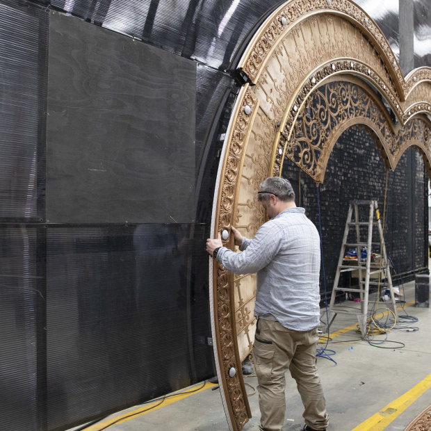 Crew install the heart-shaped portal that forms the centrepiece of Moulin Rouge! The Musical!
