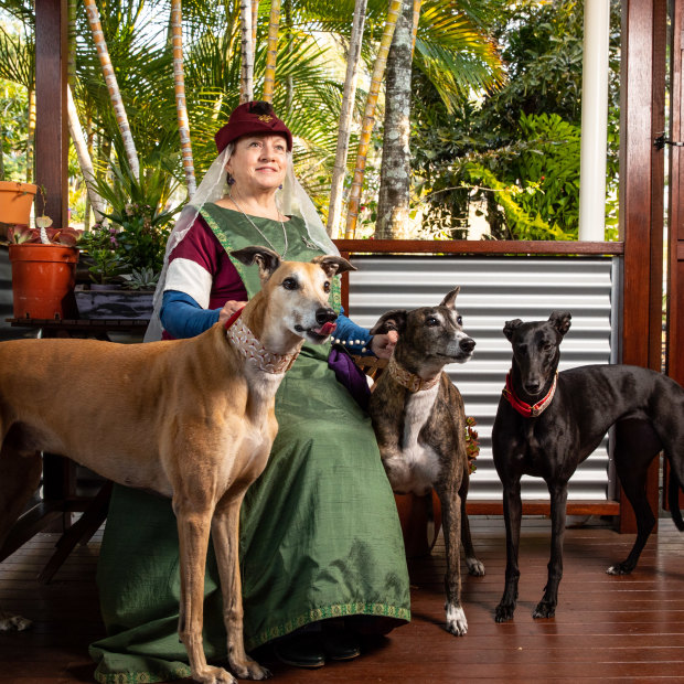 Susan Cooper – in her noblewoman outfit – at her Gold Coast home with her three greyhounds (from left) Rory, Lucy-lou and Marley.
