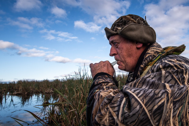 Duck hunter Dave Smeaton using his caller to lure ducks in.