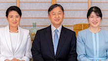 In this photo provided by Japan's Imperial Household Agency, Japan's Emperor Naruhito, Empress Masako, left, and their daughter Princess Aiko pose for a photograph during a family portrait session ahead of the New Year, at the Imperial Palace in Tokyo on Dec. 21, 2021. (Imperial Household Agency of Japan via AP)
