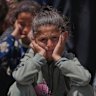 A Palestinian girl waits to collect donated food from a distribution kitchen in Deir al-Balah, Gaza Strip, on Friday.
