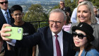 Prime Minister Anthony Albanese and Rebecca Hack (in grey) at the Mount Coot-Tha Lookout in Brisbane.
