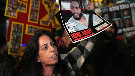 Einav Zangauker holds a poster of her son, Matan, at an earlier protest in February.