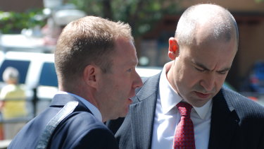 US Attorney John Anderson, right and federal prosecutor Sean Sullivan converse after Arthur Perrault was sentenced to 30 years in prison on Friday.