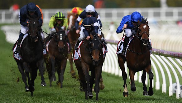 Best Solution (right) holds off Homesman (centre) to claim the Caulfield Cup.