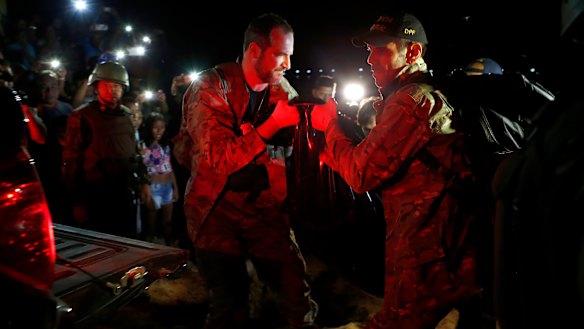 Federal police officers arrive at the pier with recovered human remains found during the search in the Amazon.
