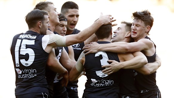 Former skipper Marc Murphy celebrates a goal with his Blues teammates in their clash with the Hawks.