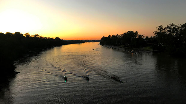 Rowers train on the Brisbane River on a cold winter morning.