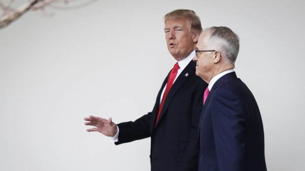 US President Donald Trump walks with former prime minister Malcolm Turnbull. 