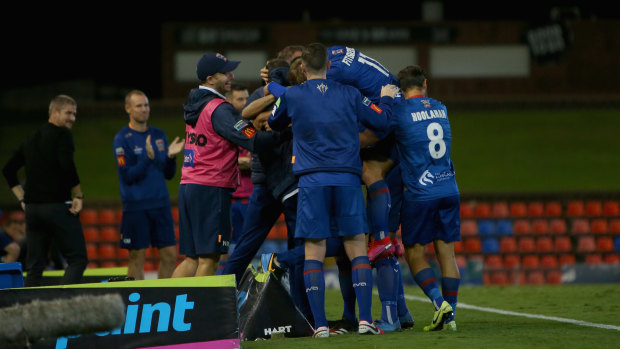 Newcastle Jets players celebrate a recent win over Melbourne City.