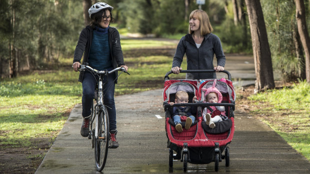 Labor spokeswoman for active transport Jo Haylen, with her children Dylan and Elliot, chats to cyclist Felicity Wade in Beaman Park, Earlwood.