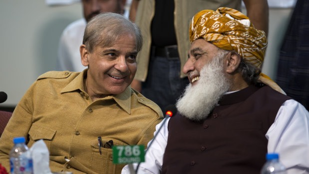 Maulana Fazlur Rehman, right, head of Pakistani religious parties alliance talks to Shahbaz Sharif, leader of Pakistan Muslim League and brother of ousted prime minister Nawaz Sharif during an All Parties Conference in Islamabad, Pakistan, on Friday.