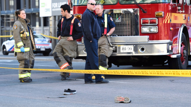 Shoes lay on the street as first responders secure the area in Toronto after a van mounted a sidewalk crashing into a crowd of pedestrians on Monday.