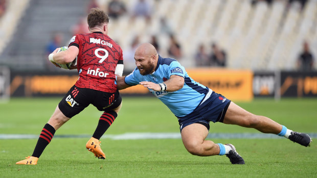 Waratahs hooker Robbie Abel attempts to tackle a Crusaders player. 
