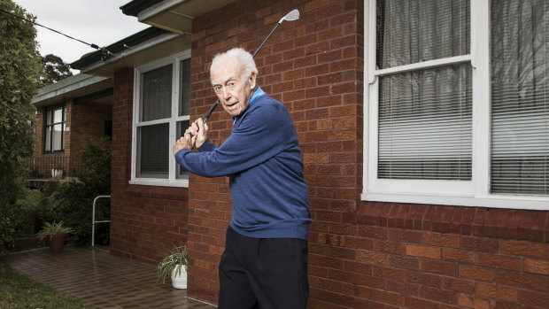 Tom Sample out the front of his Kingsford home. The 97-year-old plays golf twice a week, still does all his own shopping and mows his lawn.