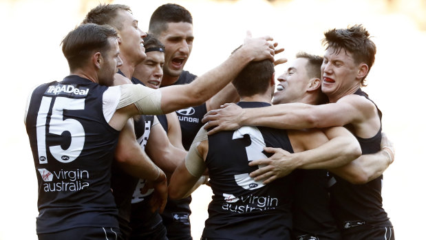 Former skipper Marc Murphy celebrates a goal with his Blues teammates in their clash with the Hawks.