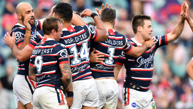 Cock-a-hoop: The Roosters gather to celebrate another score as the rout begins.