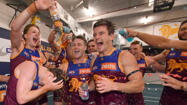 Thirsty work: Lions celebrate with a sports drink after their upset win over reigning premiers West Coast.