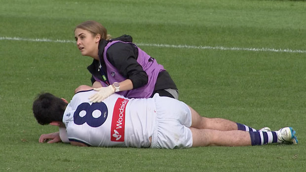 Fremantle Docker Andrew Brayshaw receives treatment after Andrew Gaff's behind-play punch.