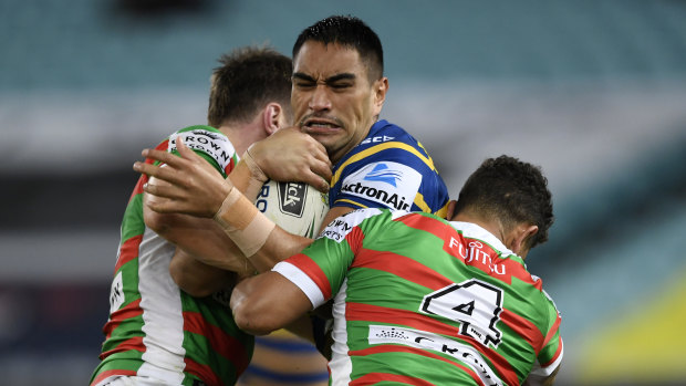 Big hit: Parramatta's Marata Niukore charges into the South Sydney defence.