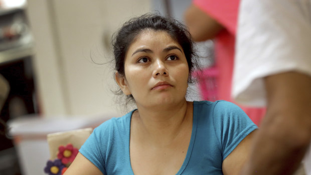 Carla, a migrant mother from El Salvador, talks with other parents at the Annunciation House,, in El Paso, Texas. Thirty-two parents separated from their children are staying at the home as they wait to be reunited with their children.
