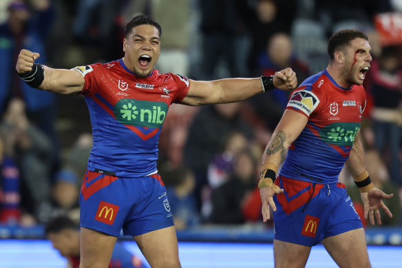 Leo Thompson and Adam Elliott celebrate Newcastle’s shock win over Melbourne.