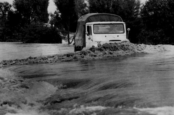 A truck battles its way along a flooded road near Geelong.