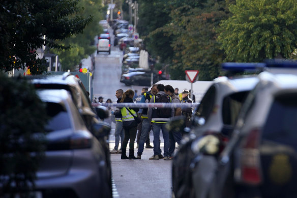 Police officers cordon off the area after a shooting in Madrid, Spain.