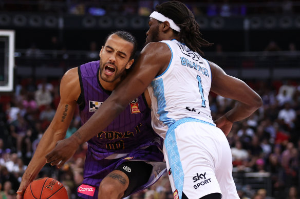 Xavier Cooks gets crunched by the Breakers’ defence.