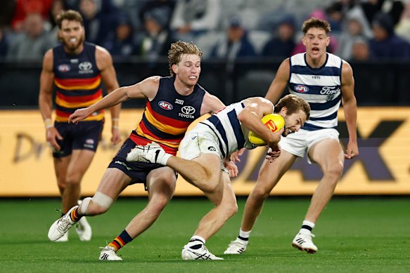 Max Michalanney looks to wrap Tom Atkins up in a tackle.