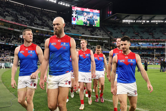 Demons skipper Max Gawn and his team look dejected as they leave the ground following an abject performance against Collingwood.