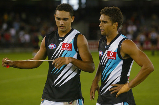 Shaun and Peter Burgoyne after Shaun’s AFL debut in 2002.